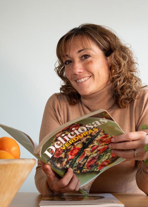 Mireia Cervera nutritionist and dietician reading magazine smiling to camera at Camiral Resort