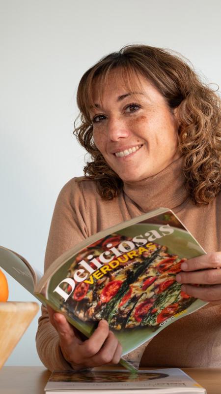 Mireia Cervera nutritionist and dietician reading magazine smiling to camera at Camiral Resort