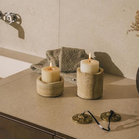 Two lit candles in elegant stone candleholders at luxury spa at 5* Resort