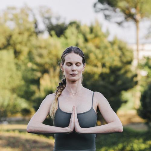 Woman meditates outside at the Camiral a Quinta de Lago Wellness and Health spa in Girona