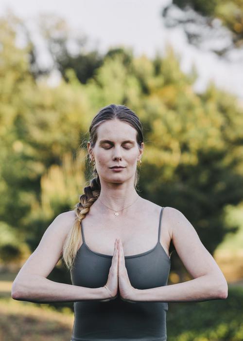 Woman meditates outside at the Camiral a Quinta de Lago Wellness and Health spa in Girona
