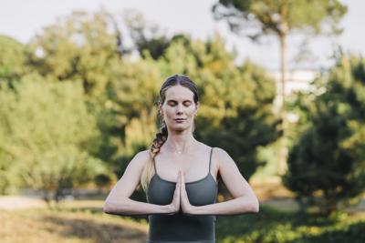 Woman meditates outside at the Camiral a Quinta de Lago Wellness and Health spa in Girona