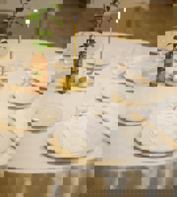 Elegant Private Dining Table Setting With White Tablecloth And Floral Centrepiece