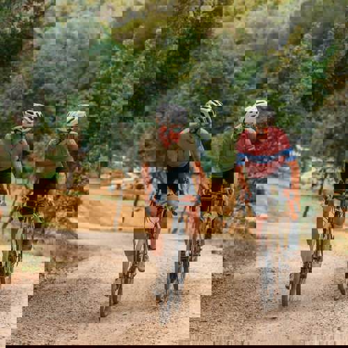 Two Cyclists Riding Gravel Bikes Through Forest Trails at PGA Catalunya Resort in Girona