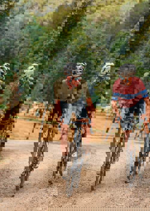Two Cyclists Riding Gravel Bikes Through Forest Trails at PGA Catalunya Resort in Girona
