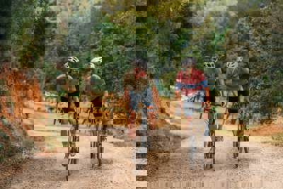 Two Cyclists Riding Gravel Bikes Through Forest Trails at PGA Catalunya Resort in Girona