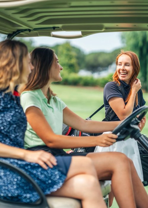 Women Enjoying Golf Buggy Ride at Camiral Tour Course
