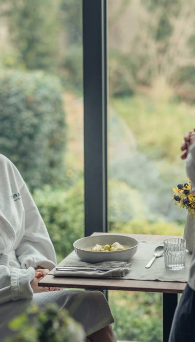 Woman enjoys rejuvenating meal at Camiral A Quinta do Lago Resort wellness spa
