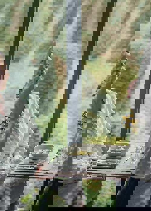 Woman enjoys rejuvenating meal at Camiral A Quinta do Lago Resort wellness spa