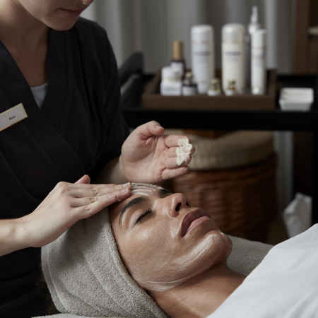 Woman recieves caviar facial firming treatment at 5* luxury resort wellness spa