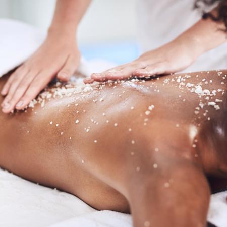 Holistic Exfoliating Massage on womans back at luxury 5* resort wellness spa in Costa Brava
