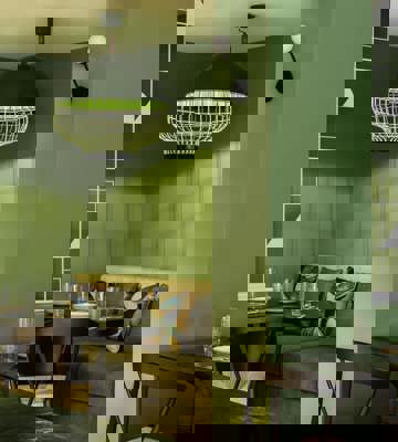 Modern Green Dining Area With Booth Seating at Camiral Bellas