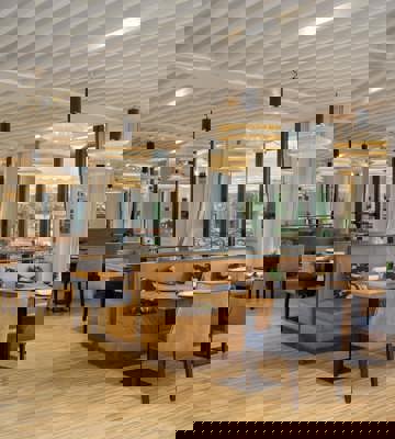 Camiral Bistro Restaurant Interior with Contemporary Dining Area and Garden Views