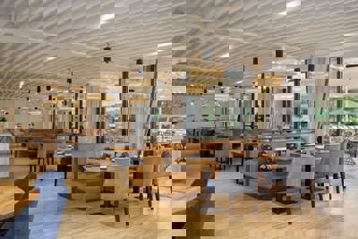 Camiral Bistro Restaurant Interior with Contemporary Dining Area and Garden Views