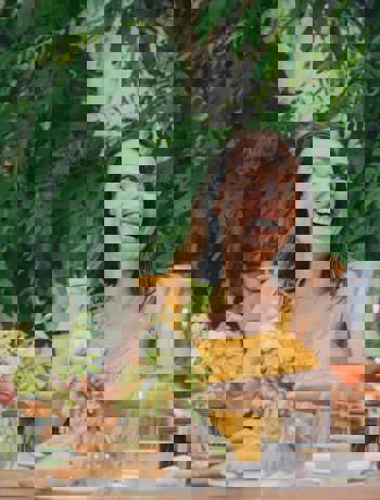 Guest Enjoying Outdoor Dining and Rosé Wine at Camiral Resort Terrace