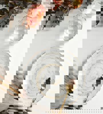 Minimalist Table Setting with Ceramic Plate, Gold Spoon, Water Glasses