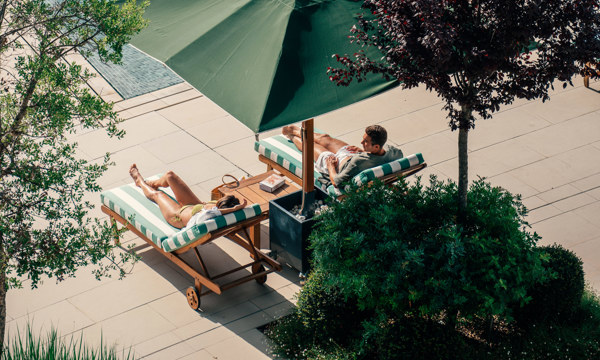 Couples Relaxing at Hotel Camiral Pool - Best Resort Offers in Girona