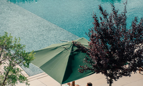 Couples Relaxing at Hotel Camiral Pool - Best Resort Offers in Girona