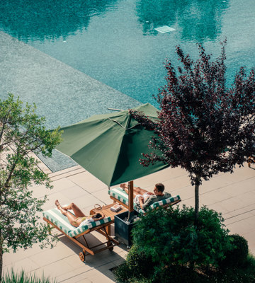Couples Relaxing at Hotel Camiral Pool - Best Resort Offers in Girona