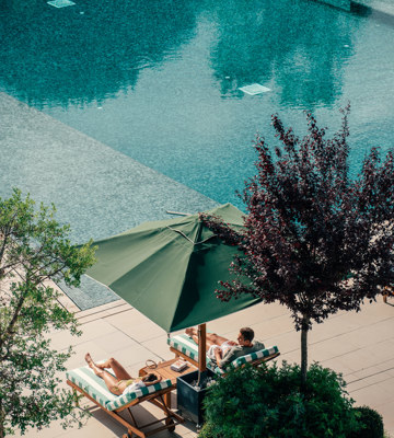 Couples Relaxing at Hotel Camiral Pool - Best Resort Offers in Girona