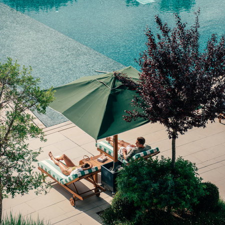Couples Relaxing at Hotel Camiral Pool - Best Resort Offers in Girona