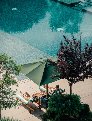 Couples Relaxing at Hotel Camiral Pool - Best Resort Offers in Girona