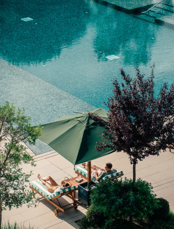 Couples Relaxing at Hotel Camiral Pool - Best Resort Offers in Girona