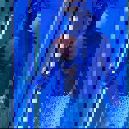 Man in white striped shorts in cryotherapy machine at Camiral 5* PGA Resort