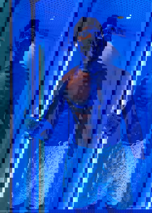 Man in white striped shorts in cryotherapy machine at Camiral 5* PGA Resort