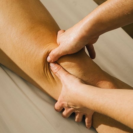 Knee massage in soft light close up at luxury wellness spa in Girona