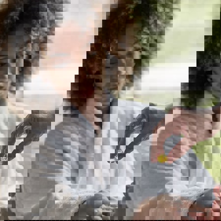 Woman in robe received massage oil on wrist for hand massage and manicure at luxury resort