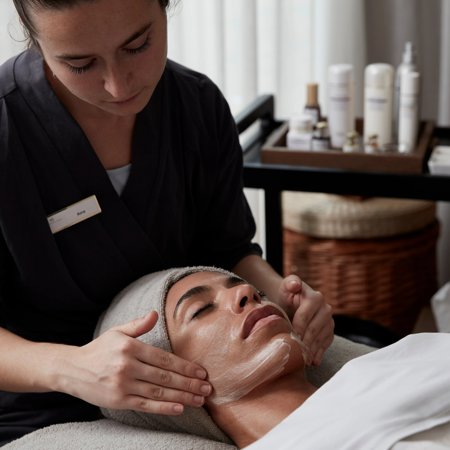Woman receives facial at luxry 5* wellness spa in Costa Brava