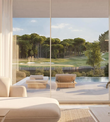 Modern Camiral suite interior with views of a private pool and golf course.
