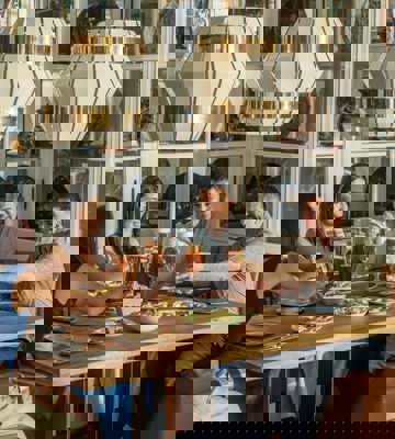 Friends Enjoying Drinks and Sharing Plates at Camiral Bistro Restaurant