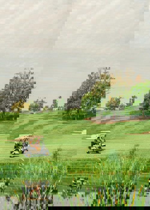 Woman Driving Golf Car at Camiral with 4 Nights Golf Escape in Girona