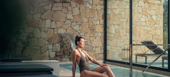Camiral Wellness Centre Thermal Pavilion with woman in grey swimsuit relaxing