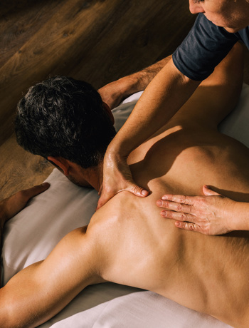 Man recieves back and shoulder massage treatment at Camiral wellness spa in costa brava