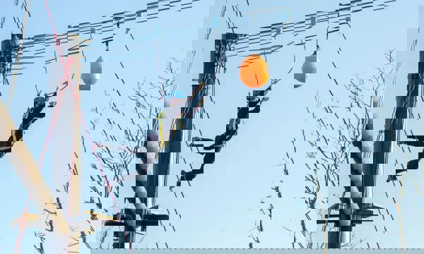 Man on zipline jumps to complete obstacle on elevated platform