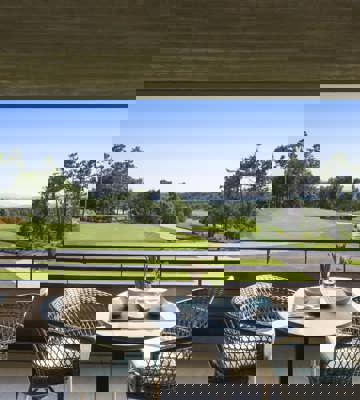 Outdoor Terrace Dining with Panoramic Golf Course Views at Camiral Resort