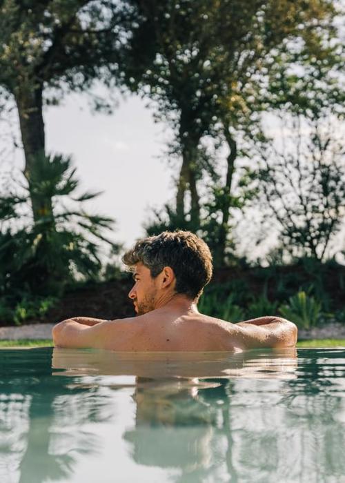 Man enjoys relaxig swim at 5* luxury wellness spa in Costa Brava