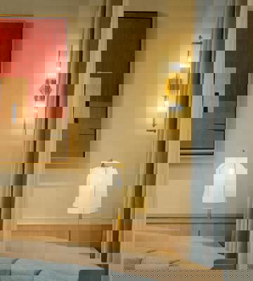 Elegant Restaurant Interior With Soft Lighting, Contemporary Wall Art And Upholstered Seating