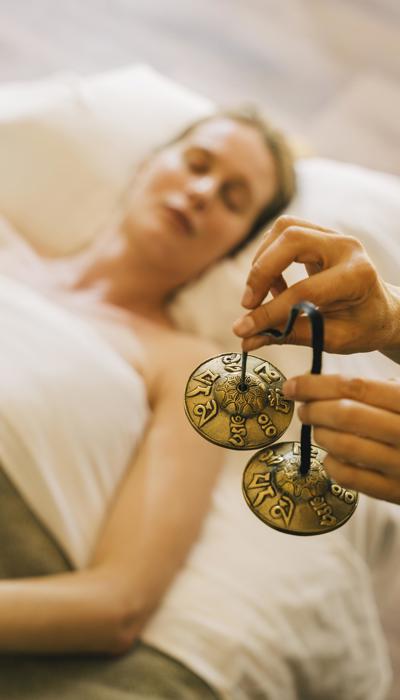 Woman with eyes closed experiences mindfullness treatment at luxury wellness spa