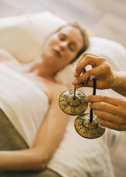 Woman with eyes closed experiences mindfullness treatment at luxury wellness spa