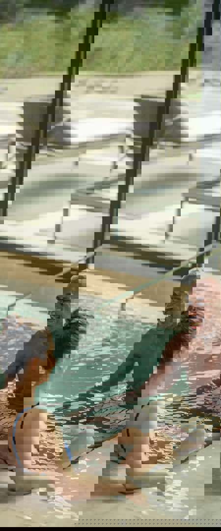 Man and womam swim and enjoy Camiral Wellness Centre Thermal Pavilion