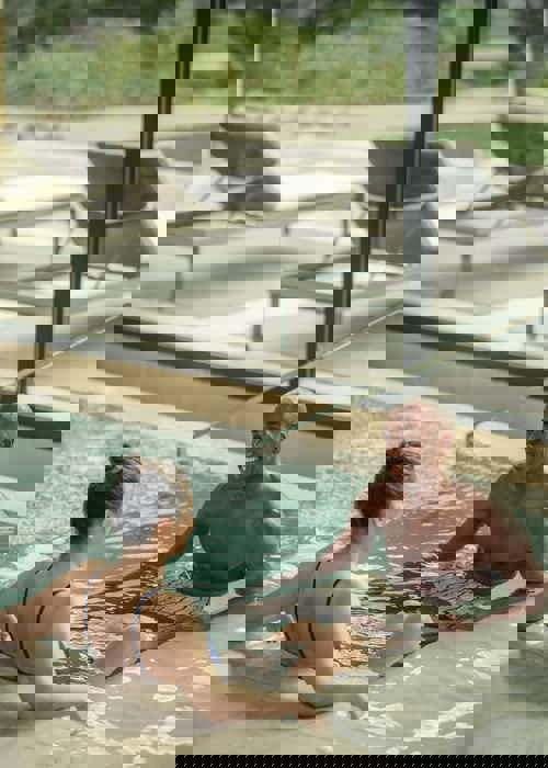 Man and womam swim and enjoy Camiral Wellness Centre Thermal Pavilion