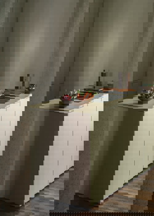 Soft tones modern kitchen with wooden floors and wooden bowl of fruit and vegetables