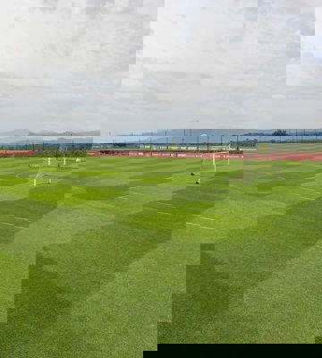 Professional Football Training Pitch with Goalposts and Mountain Backdrop in Spain