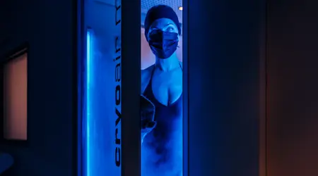 Cryotherapy machine with woman in swim cap and black mask at Camiral Wellness Centre Girona