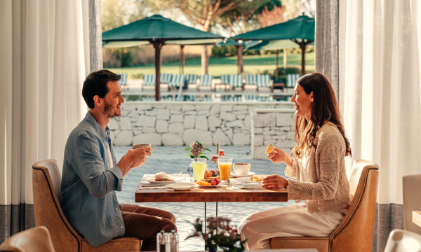 A Happy Couple Having Breakfast at Hotel Camiral 