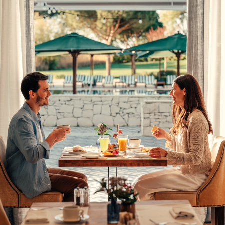 A Happy Couple Having Breakfast at Hotel Camiral 